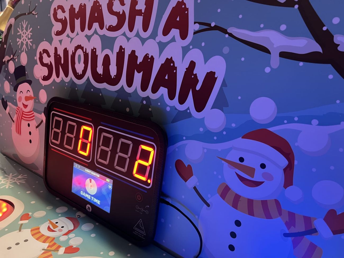 The Whack a Snowman digital scoreboard showing both players' scores with the countdown running
