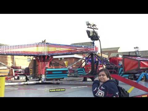Twister Sizzler fairground ride operating with riders aboard